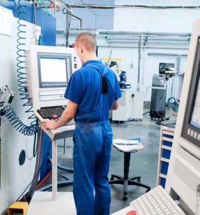 Worker operating CNC machine center